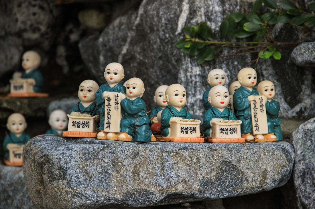 white ceramic figurines on gray concrete surface