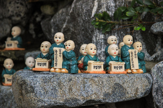 white ceramic figurines on gray concrete surface