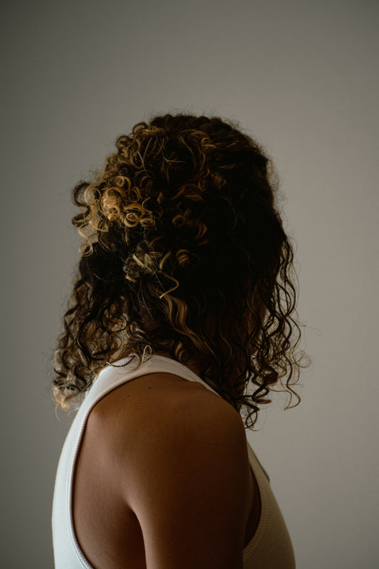 a person with the hair in a bun