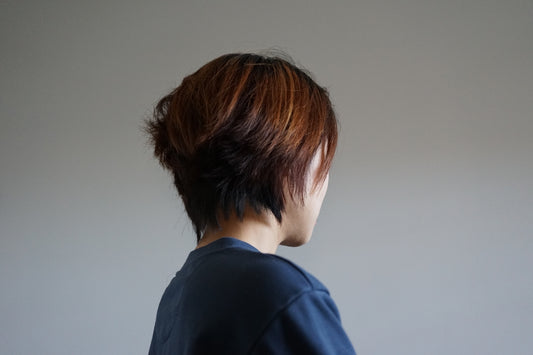 the back of a woman's head with short hair
